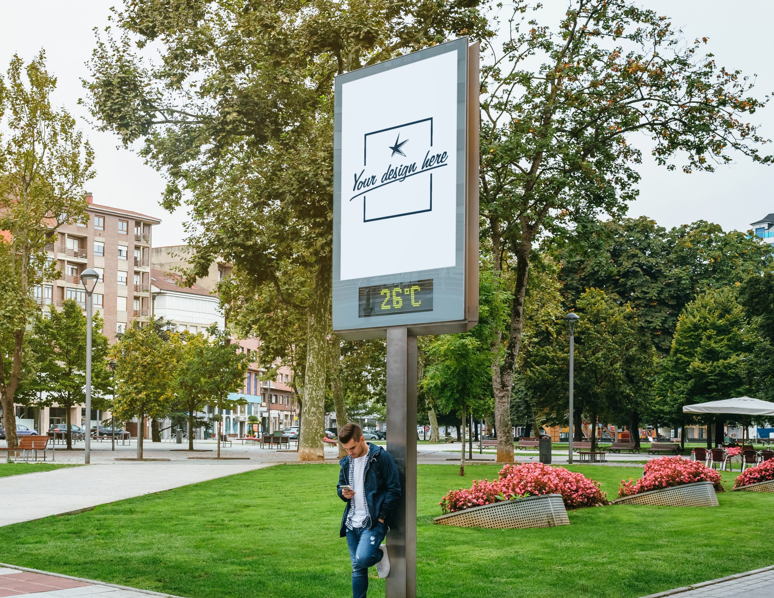 Man looking mobile leaning on a customizable billboard Man looking at mobile phone image